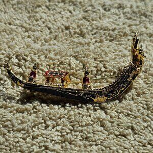 The golden created sapphire boat pin